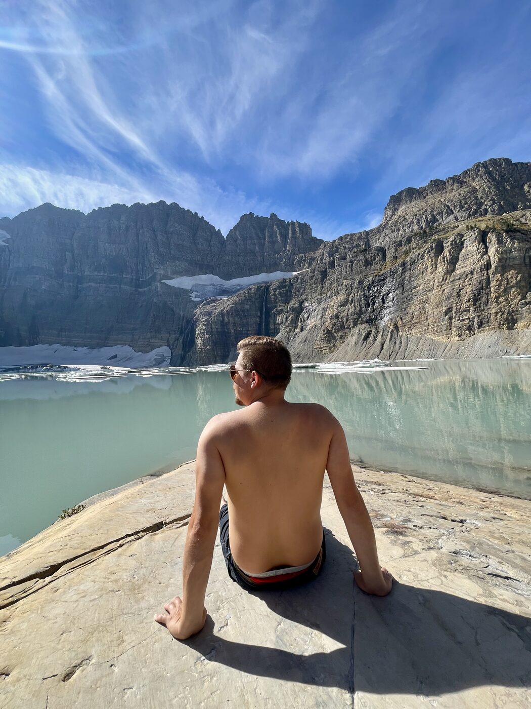 Jesse sitting above a glacier lake in Glacier National Park
