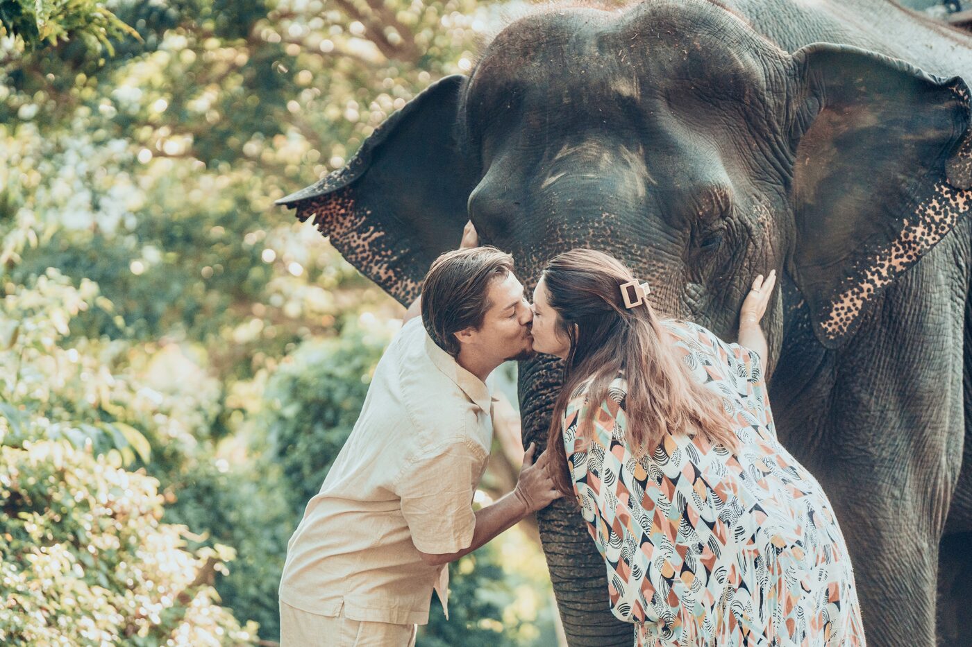 Jesse and Karlee sharing a kiss beside an elephant