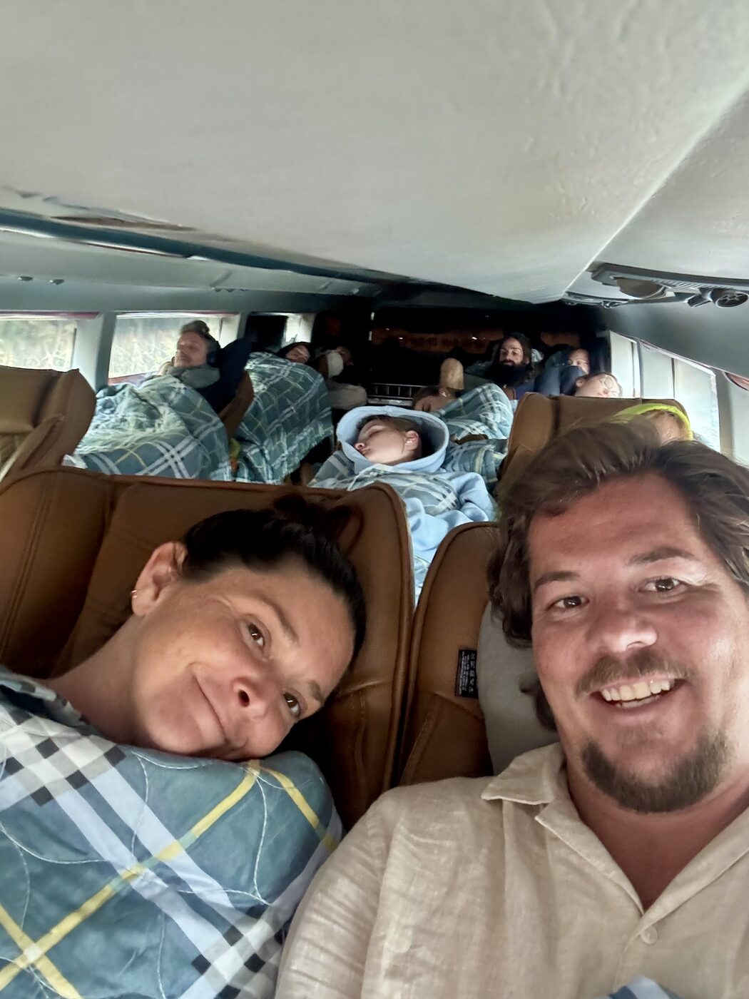 Karlee and Jesse tucked into their sleeper bus bunks