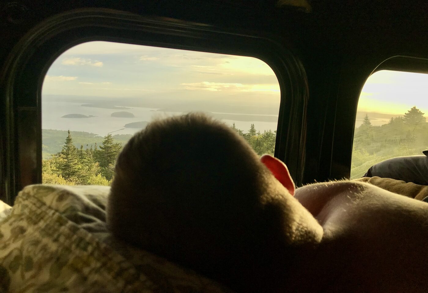 Morning light over the islands of Frenchman Bay, seen from the bed through the van window