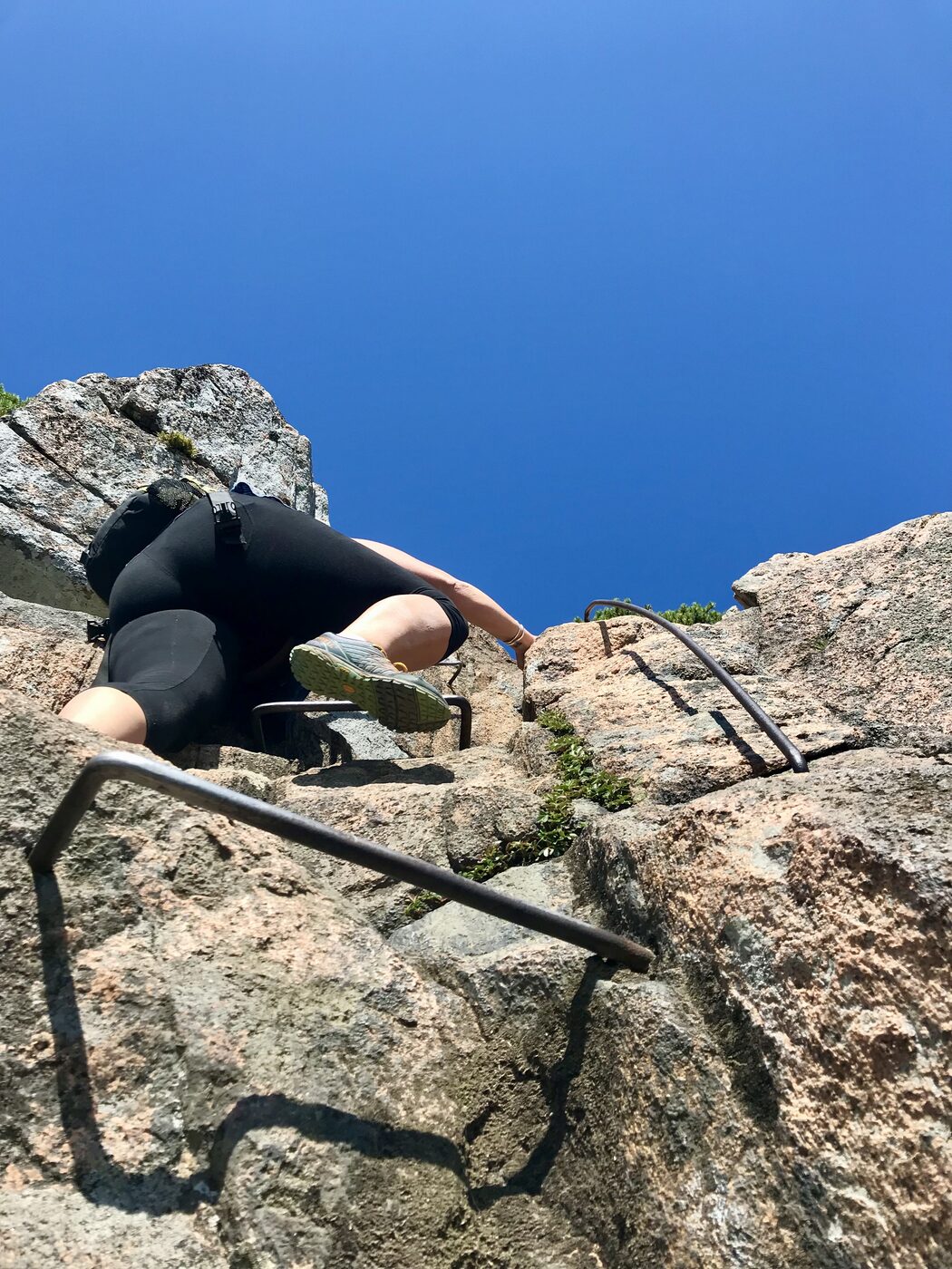 Pressed flat against the rock on an iron rung section of the Beehive trail
