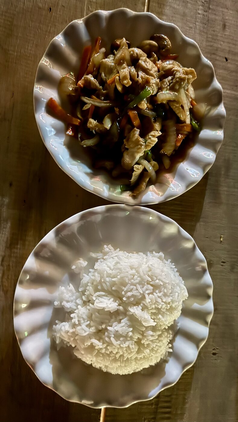 Laap and sticky rice served in simple dishes