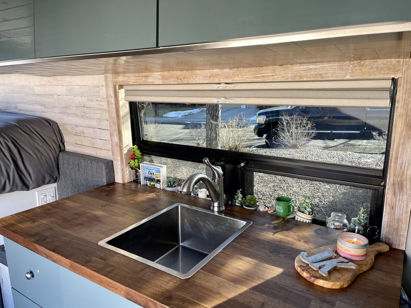 The galley sink and butcher block counter under the long side window
